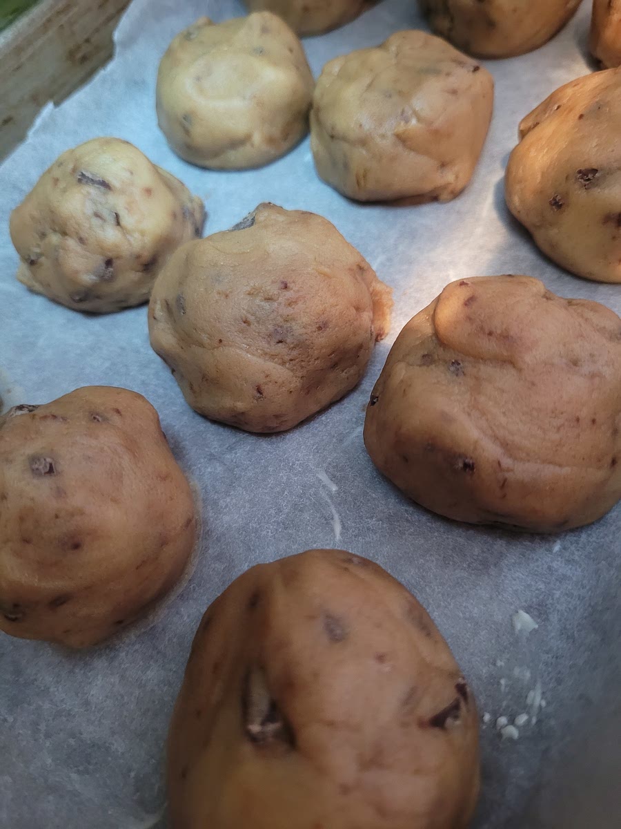 Ball the dough up and lay them on a baking tray, lined with baking paper and spreaded with butter. <Optional>Place them in the fridge overnight Bake until golden brown
