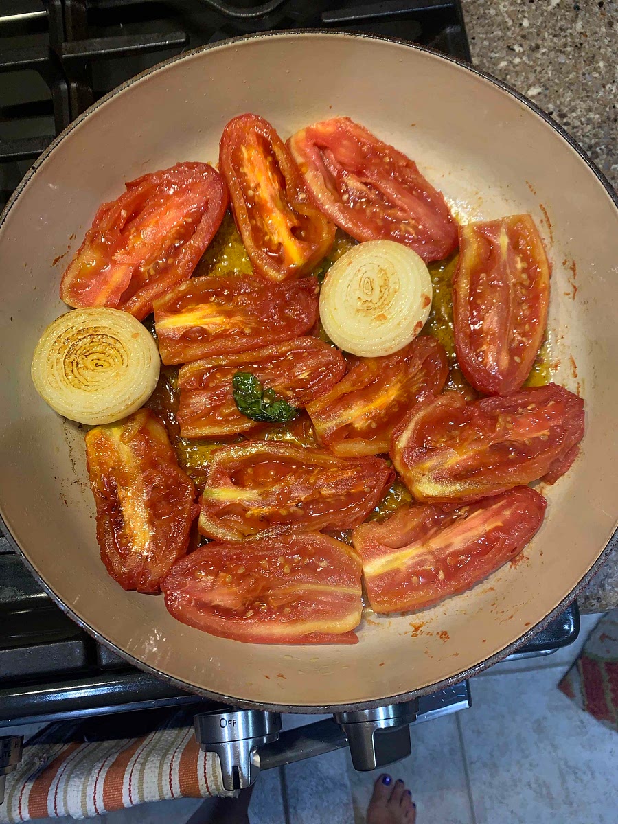 Add Olive Oil to the Skillet Add the two half’s of the Onion Put in the Tomatoes Cook Until Tomatoes are Tender Put in Garlic and Basil and cook some more Take out the Onion With a Masher, Mash together Salt and Pepper to taste