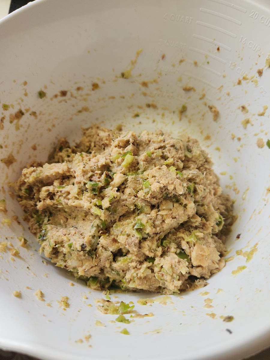 Add old bay seasoning, lemon juice, cayenne pepper, eggs, vegetables, flour and mix