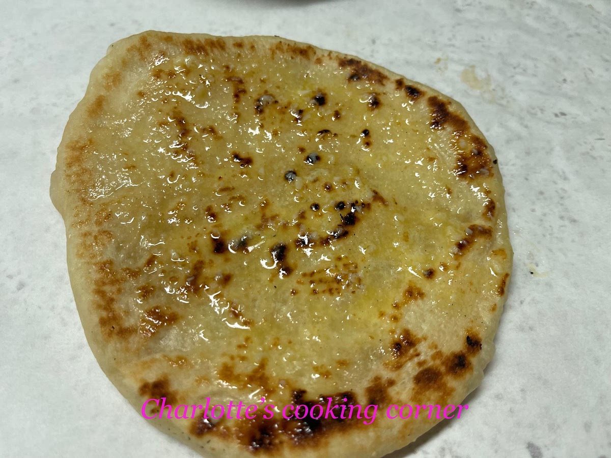 Brush garlic butter and garnish with chopped coriander.