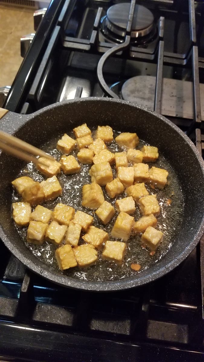 Cook all sides of the tempeh until it's golden brown.