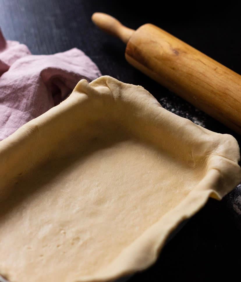 Mix together flour, butter, sour cream and baking powder. You will have a wonderful soft dough. Roll it out and shape in a pan.