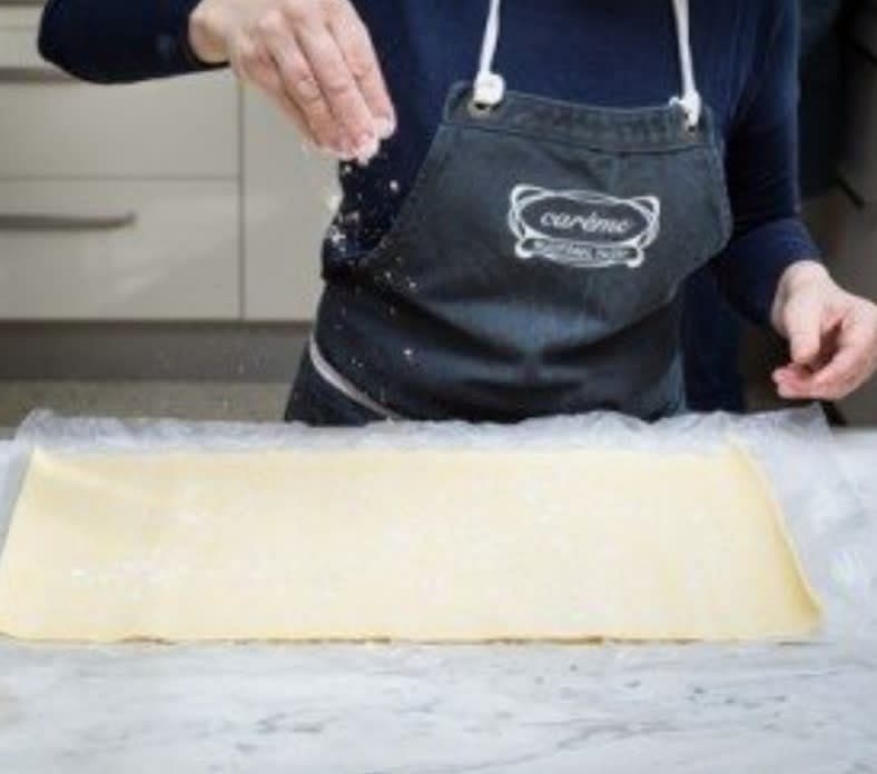 Unroll sheet of pastry, lightly dust surface and underside of pastry with flour.