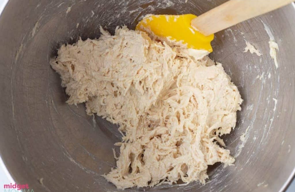 Add the cooked chicken to a bowl and shred with fork if it needs to shred. Add 3/4 cup shredded Monterey Jack cheese Or Pepper Jack cheese, garlic powder and cream cheese to the bowl and mix well so everything is combined.