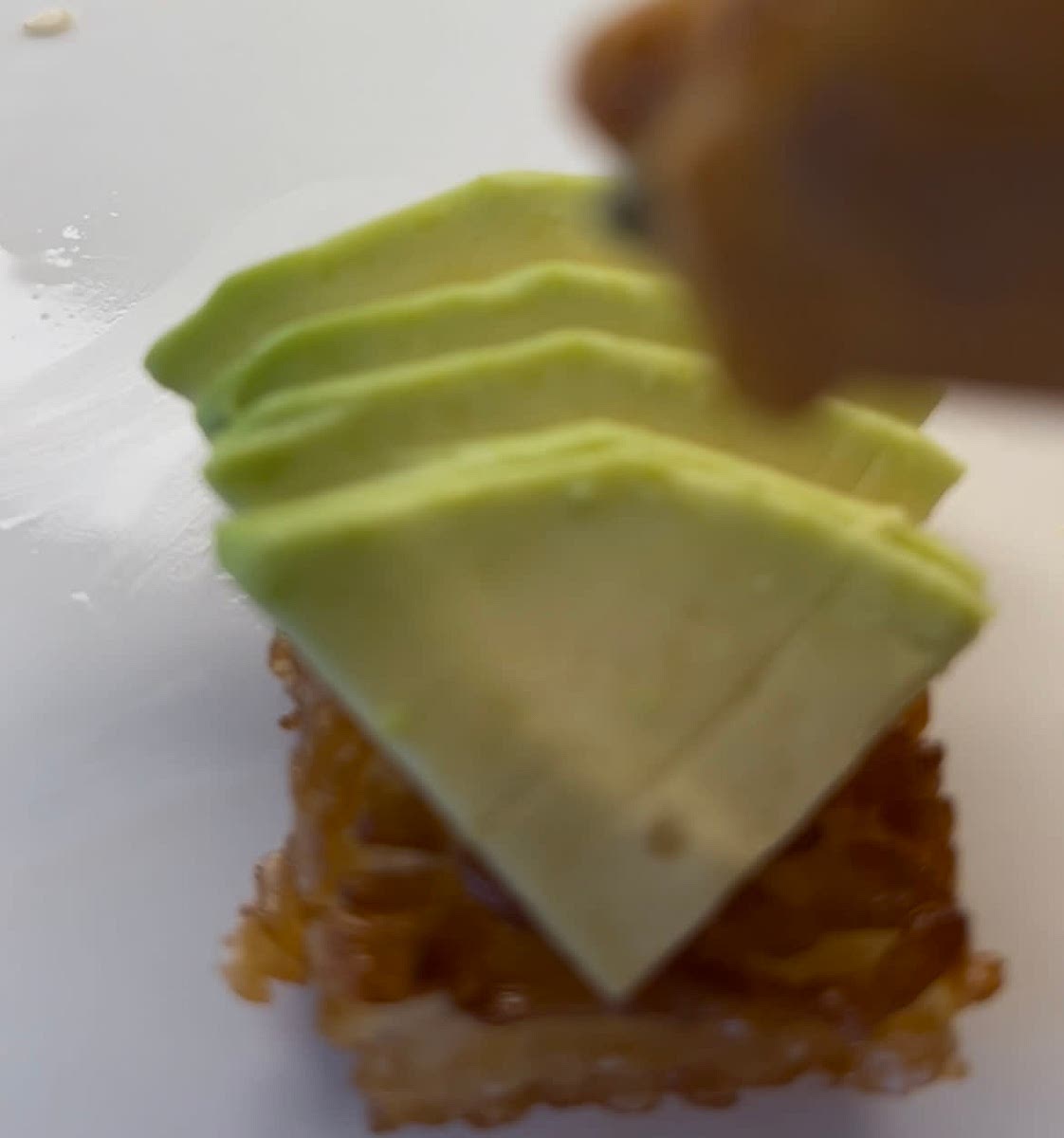 Add thinly sliced avocado on top of the fried rice.