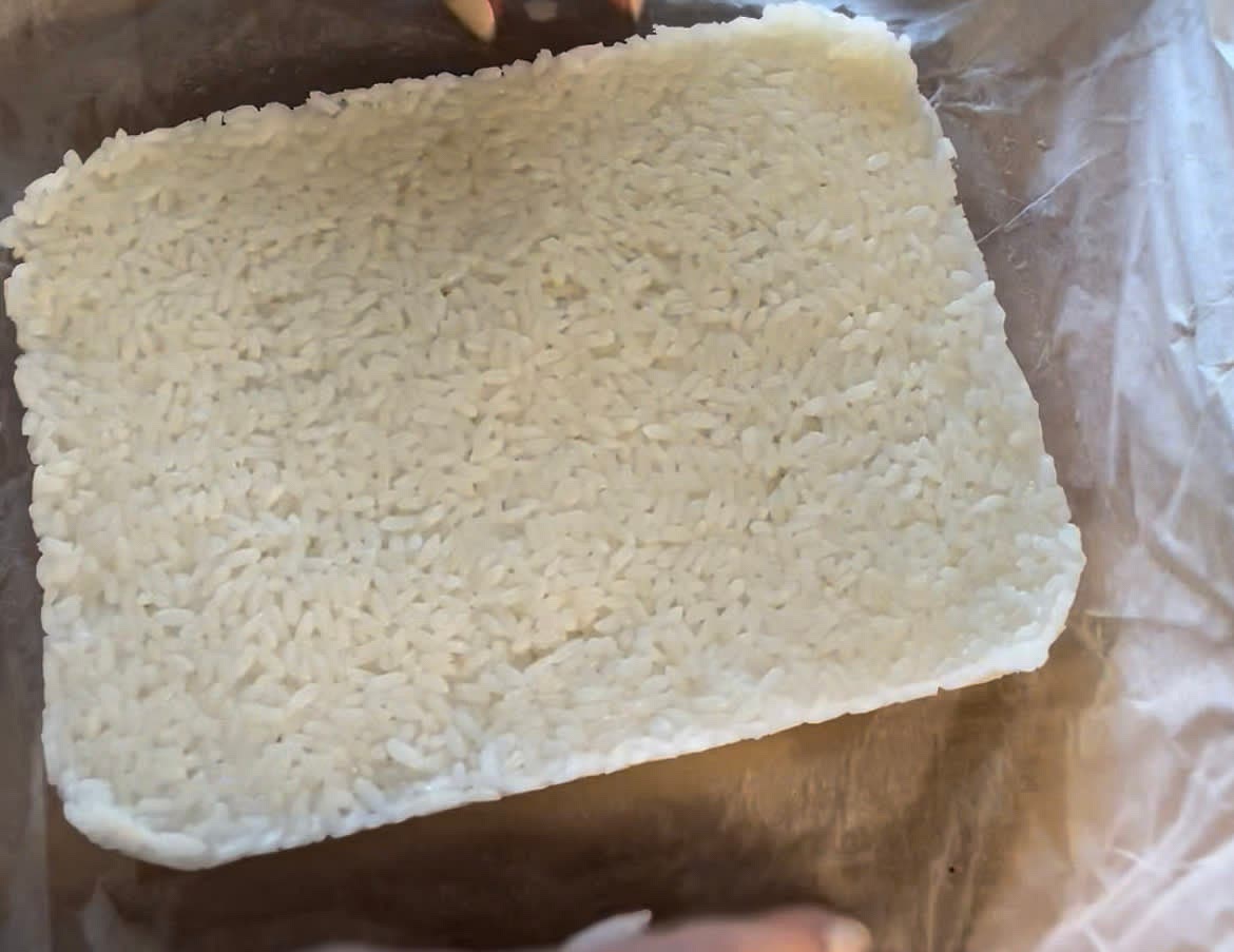Line glass pan with parchment paper and tightly pack the rice to desired thickness. Cover tightly and pop in the fridge to chill for 1 to 2 hours or overnight. To save time, chill in the freezer for 30 minutes just until it is cold and easily can be sliced.
