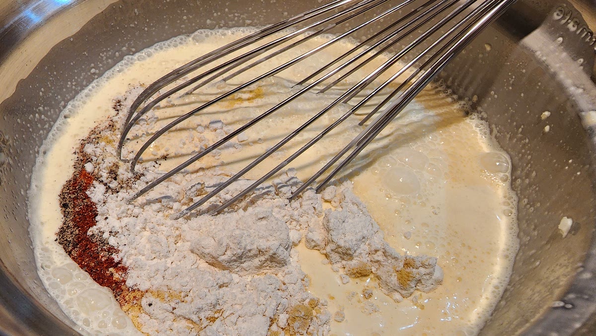 2. Add wet ingredients and mix well (beaten eggs, sour cream, heavy cream, half & half, Worcestershire sauce, grated onion)