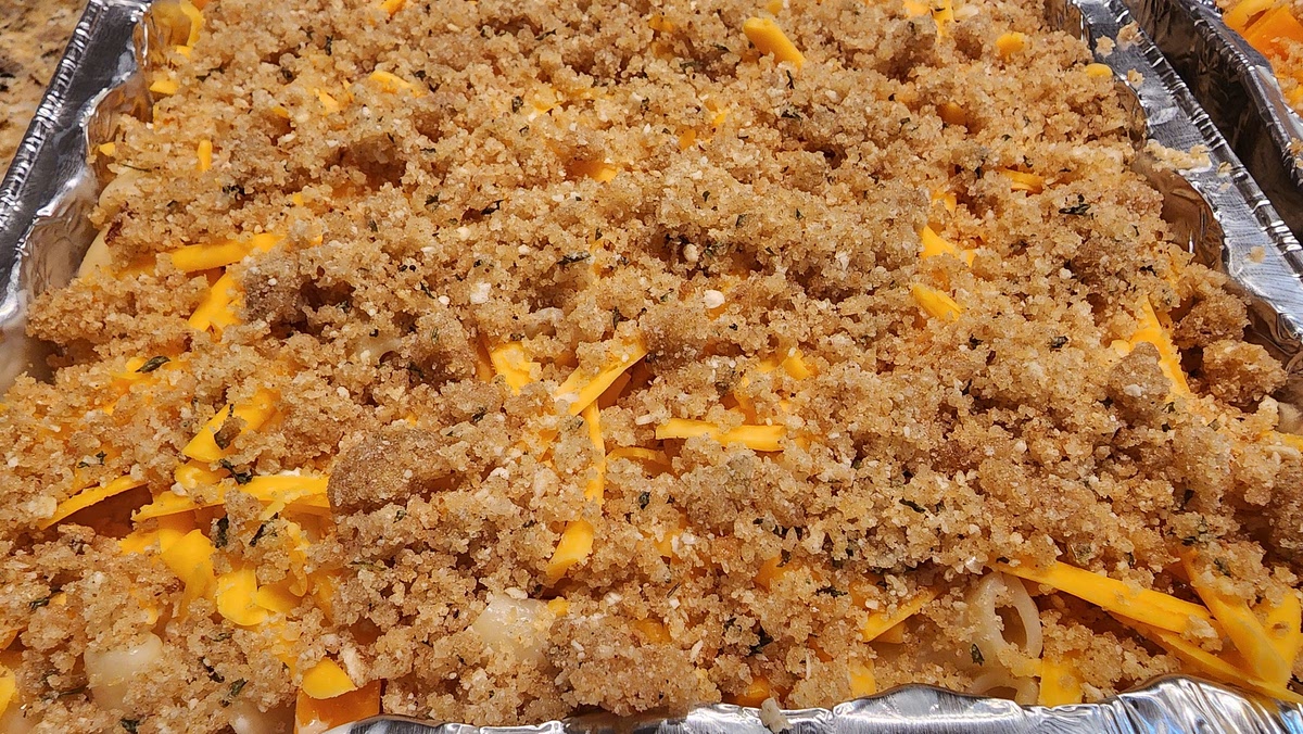 6. Spread shredded cheddar on top of macaroni and spread buttered panko crumbs on top of that