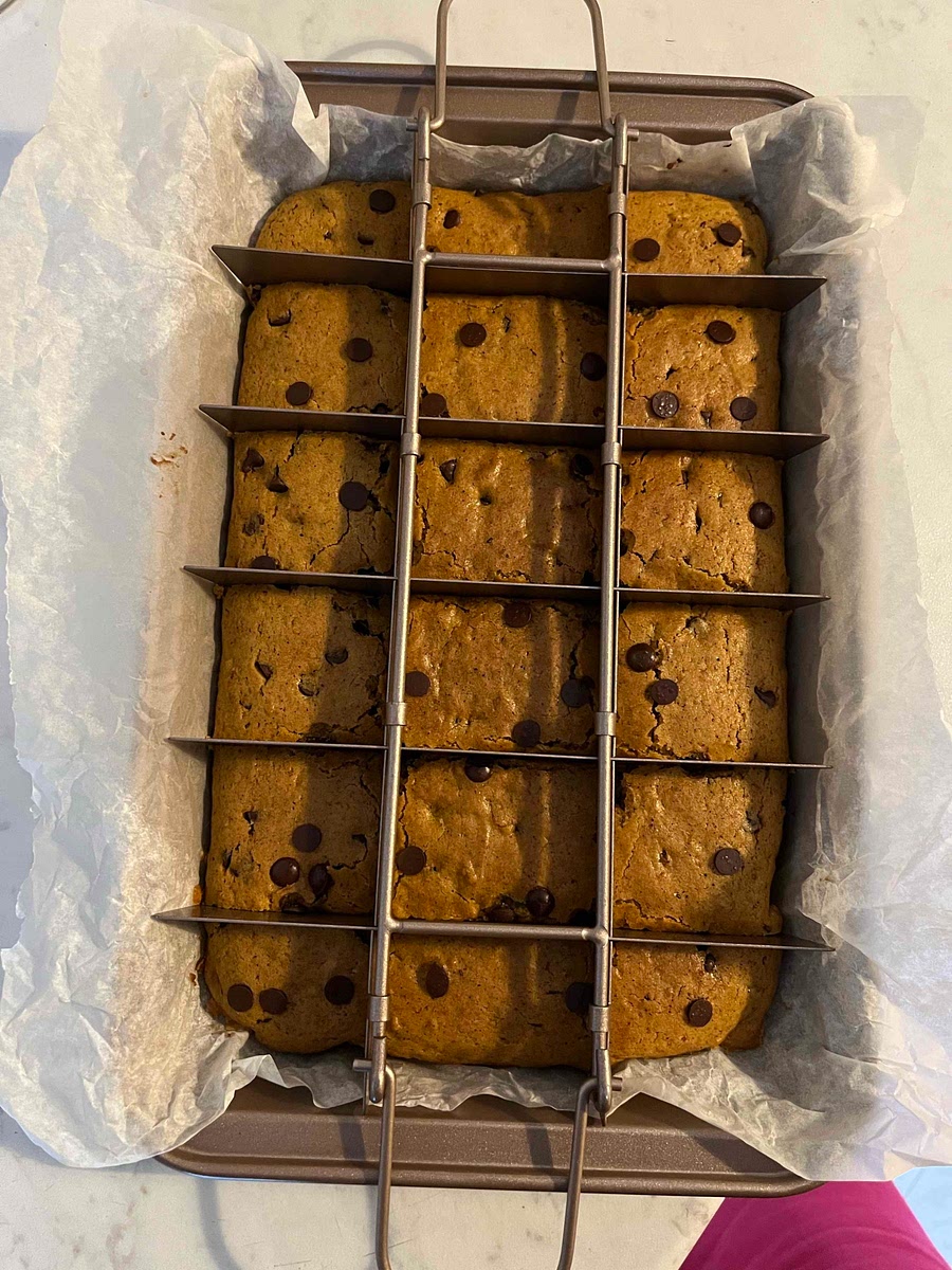 Use overhanging parchment to lift blondies out of pan. Peel away parchment and cut into squares. These Pumpkin Spice Mocha Latte Blondies are best the day and day after they are baked. They may be stored wrapped airtight for up to 3 days.