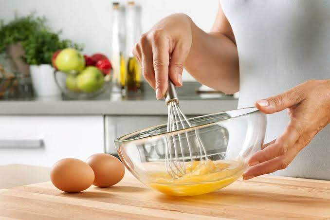 Whisk eggs with vanilla extract then add them slowly to the bowl.