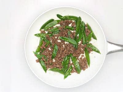 Add the mangetout to the pan and cook for 1 min or until starting to soften