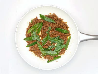Add the red Thai curry paste, ginger paste and half of the chilli flakes (can't handle the heat? Go easy!) to the pan and cook for 1 min further or until fragrant