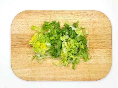 While the sauce is thickening, shred the little gem lettuce