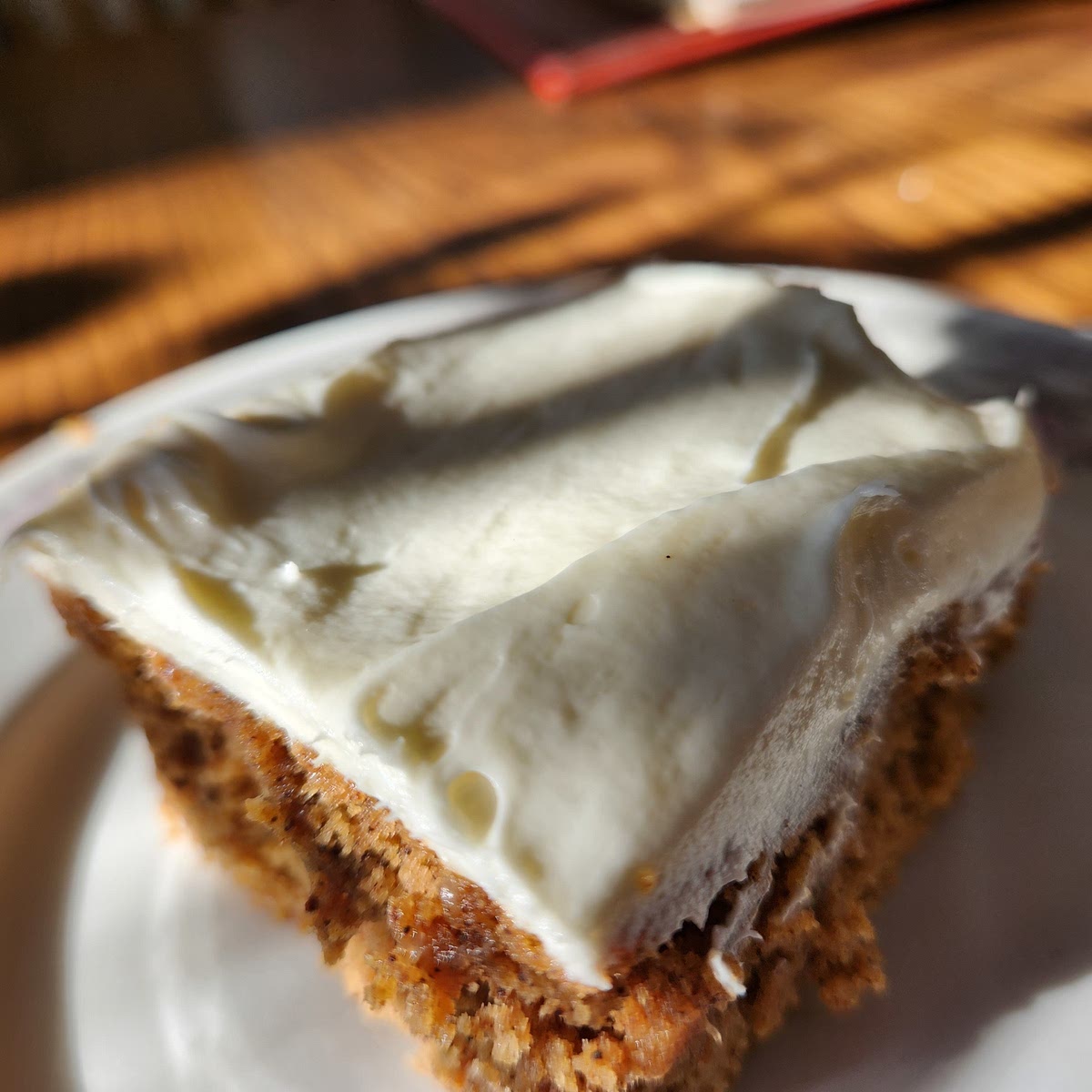 For the buttercream frosting, start with room-temperature ingredients. Cream the butter and sugar together for several minutes to a light, whipped consistency. Add the cream cheese and beat vigorously for several more minutes. Plop frosting over the cake in several spaced dollops and spread with frosting knife or spatula.
