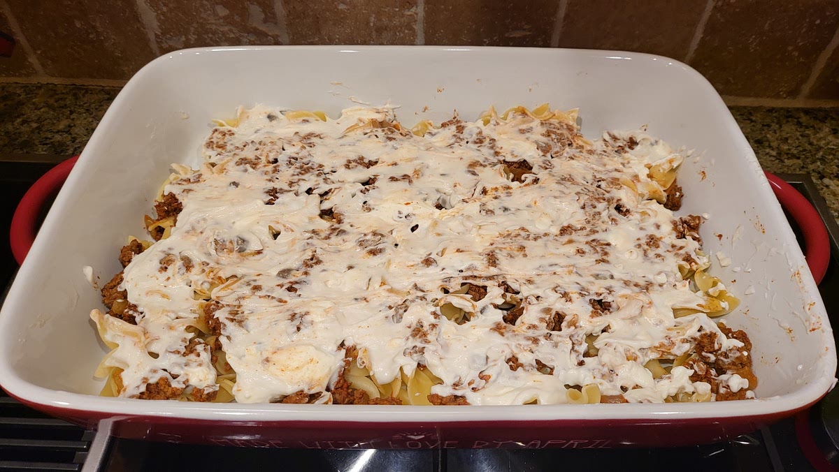 Layer Half of the White Sauce Over Meat Sauce. Flatten Evenly.
