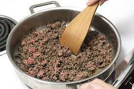 Heat a large pot over medium-high heat, add enough oil to cover the bottom and wait for oil to heat up, then add your meat and chop down with a wooden spoon to your desired chunk size.