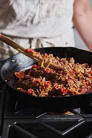 Add your chopped vegetables (onions, red peppers, celery, jalapenos, and garlic). Add your seasonings (oregano, chili powder, cumin, bay leaves). Stir and combine, browning veggies until desired level (~5-10 minutes)