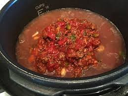 Add your tomatoes and enough chicken broth to reach the top of the sautéed meat and veggies (or you can add more if you like).
Bring to a boil, reduce heat and let simmer, stirring occasionally, for at-least 15 minutes.