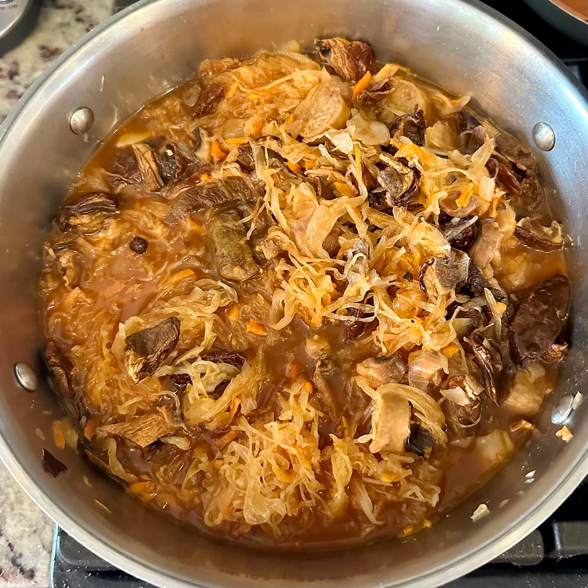 Pour tomato sauce and add sauerkraut. Once it starts to boil add bay bolete mushrooms, spices and boil bigos on low for 2-3 hours.
