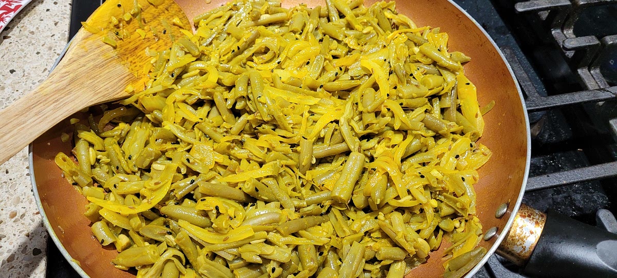 Add in turmeric, mix briefly, then add beans and drain water before adding. Lightly stir everything uncovered.