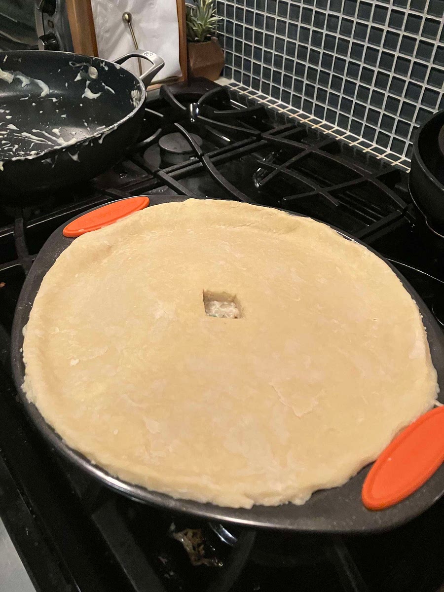 With a sharp knife cut a small diamond in middle of top crust.