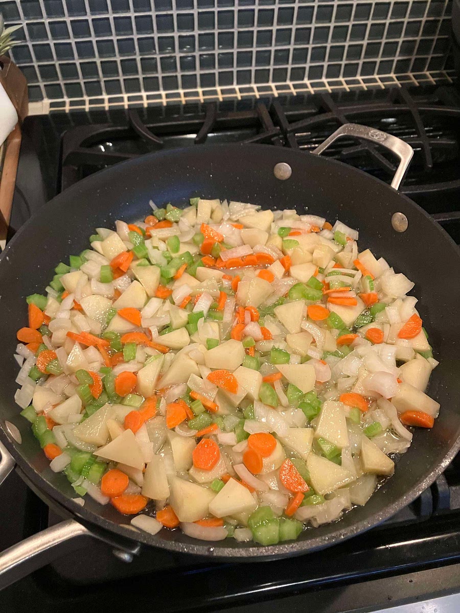 Saute onion, carrot, celery, and potato for 5 minutes until tender crisp; add peas.