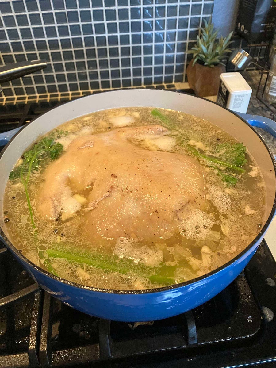 Add 2 quarts chicken broth, celery, peppercorns, parsley and bay leaf. Bring to a boil and cover.