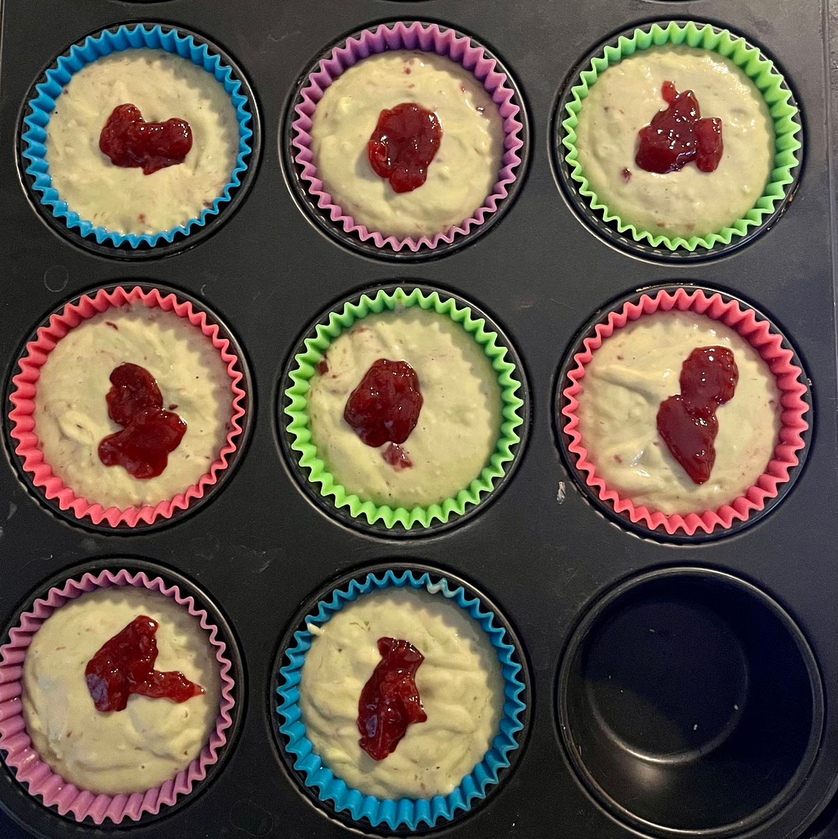 Pour the dough: Pour 1 tablespoon of batter into the muffin, then 1 tablespoon of jam in the middle and then top with the remaining batter.