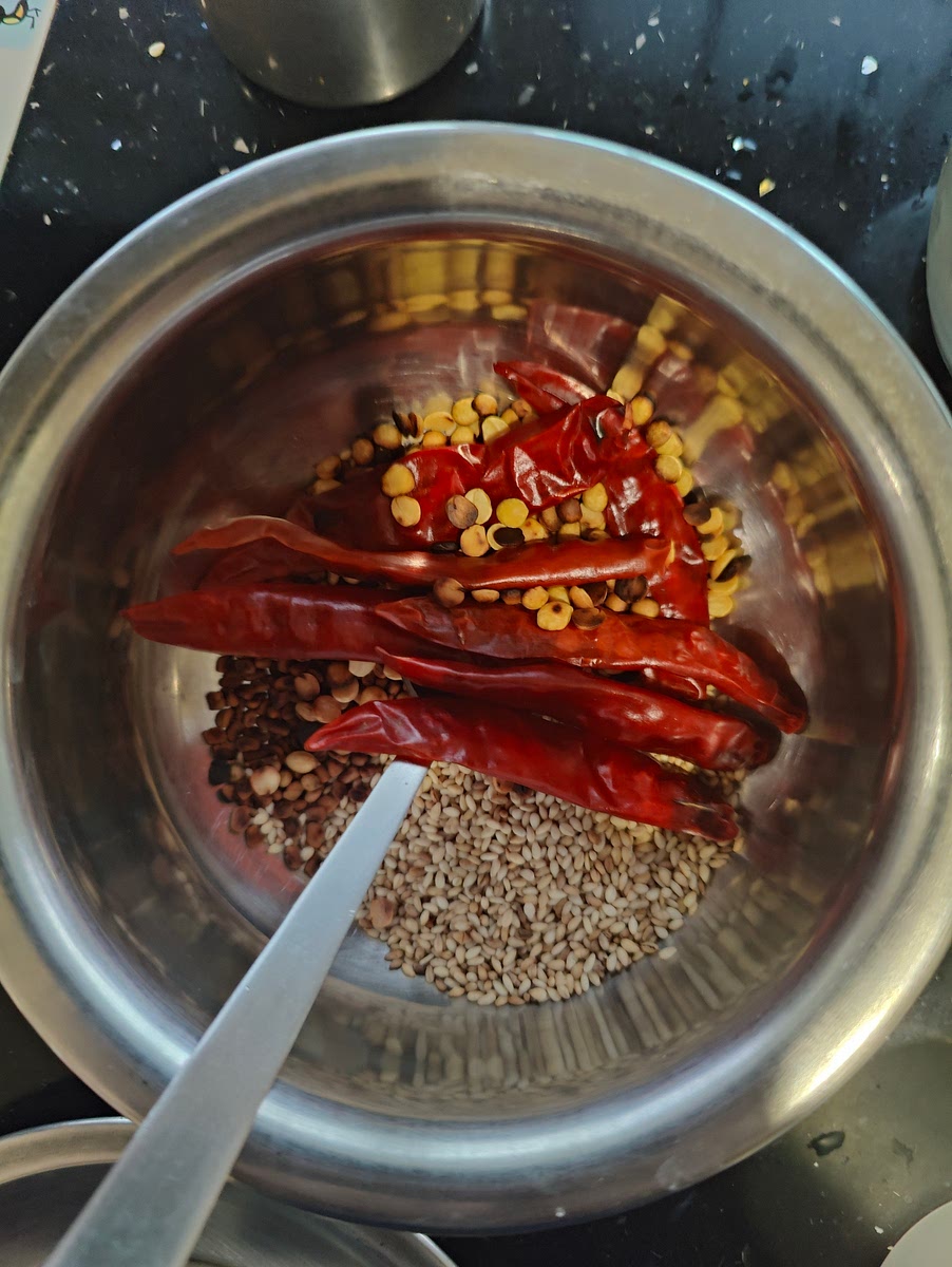 Add 1 TSP toor dal in the same vessel again, add 7 red chillies and saute. All dry only.