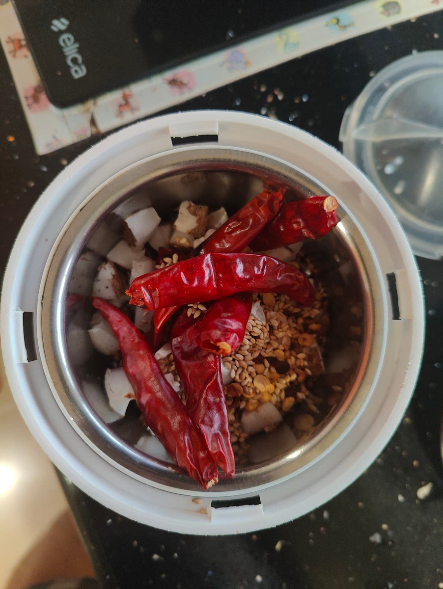 Add the cut coconut pieces to the other ingredients. Transfer them into Mixie Jar.