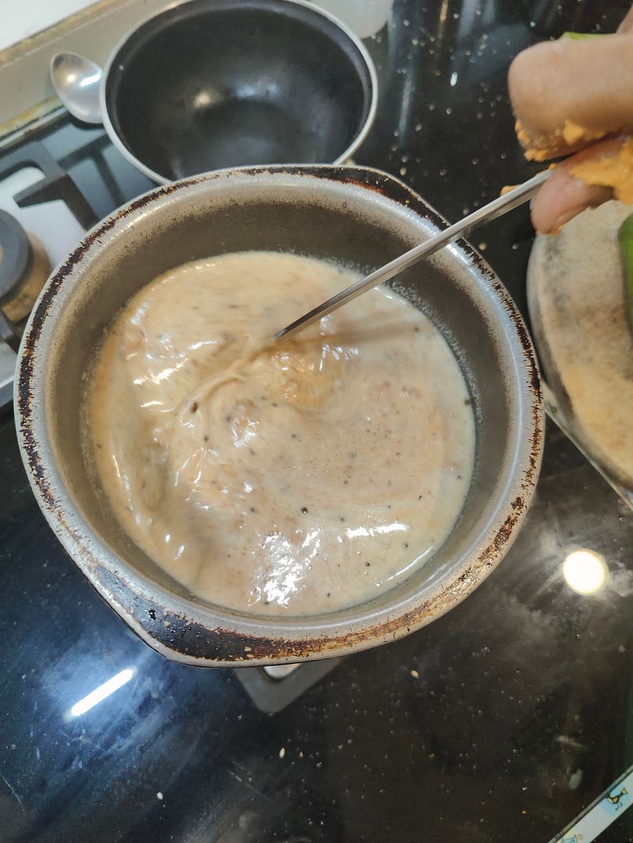 Add curd till 3/4 of the utensil, along with it add the paste to the mixture. Switch off the flame, and mix it well.