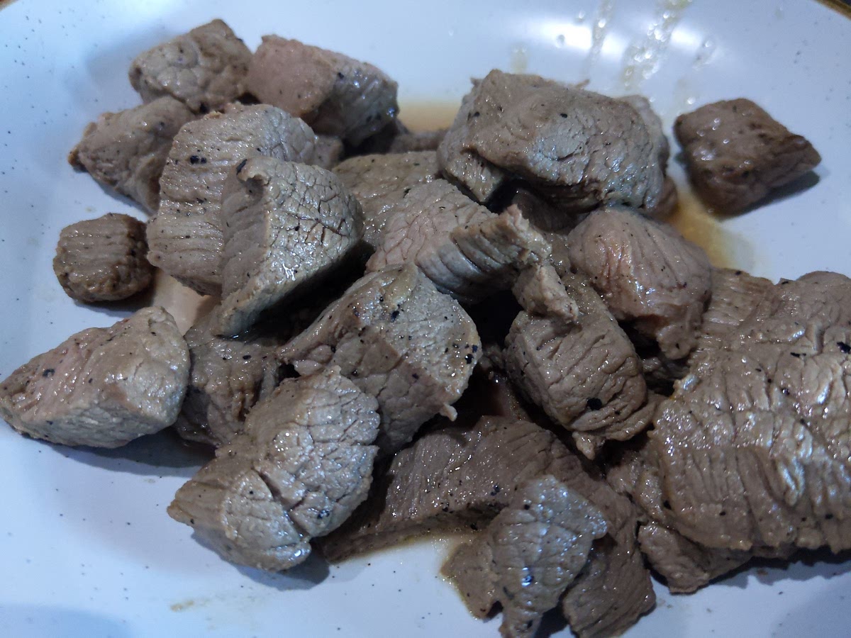 Set the oven at 180°C/Gas 4. Melt the butter in a large casserole to which you have a lid. The heat should be quite sprightly. Cut the beef into four pieces, each nicely seasoned with salt and black pepper, then lower into the lightly sizzling butter. Let the meat colour on one side, then turn it over. Peel, halve and thinly slice the onions while the meat browns. Once coloured, remove the meat to a plate and lower the heat.