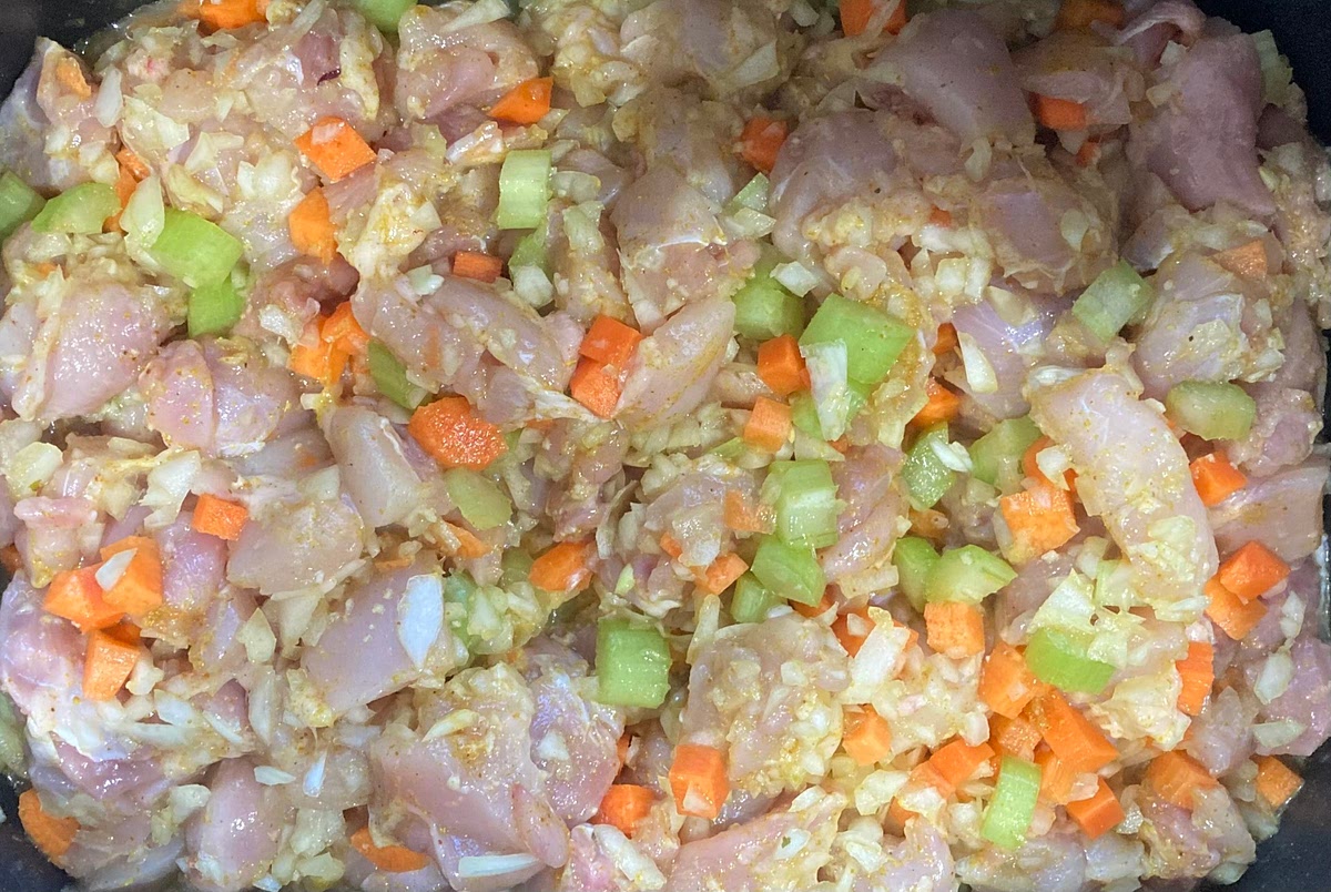 In a slow cooker, add the chicken, onion, garlic, celery, carrots, curry powder, and chicken stock.