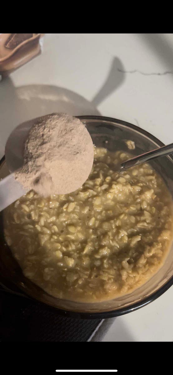 Once your oatmeal is fully cooked, remove from heat and add one scoop of your favorite chocolate protein powder.
