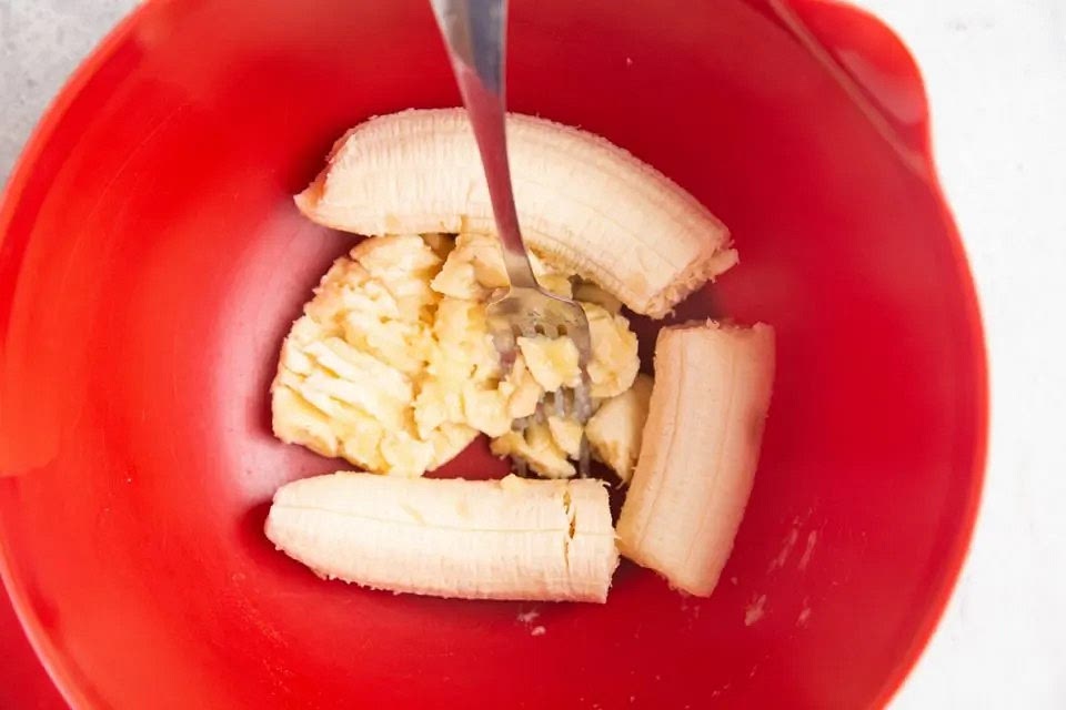 Mash the bananas in a large mixing bowl until they are very creamy (if you don’t mind chunks of banana, you can leave them chunky, but I like to mash them well).