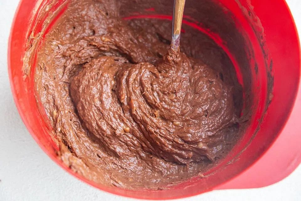 Stir in the chocolate chips (if adding) until they are well-incorporated throughout the brownie batter.