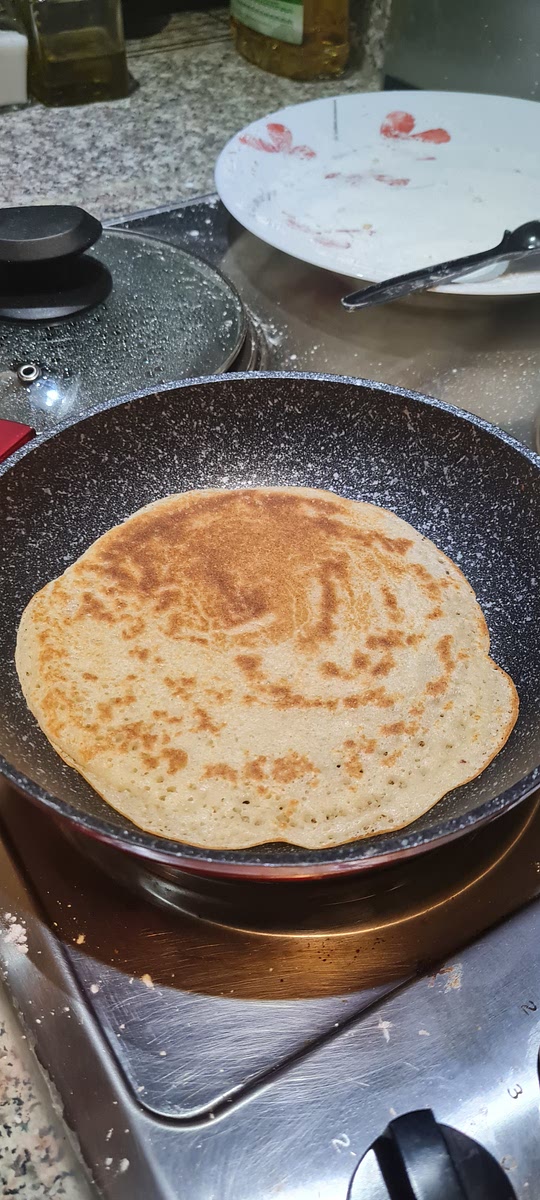 Return the pan to the heat and cover it for 2 minutes or until the edges of the bread batter start to get golden then flip the bread