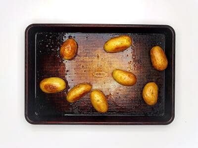 1. Preheat the oven to 200°C/ 180°C (fan)/ gas 6 Add the waxy potatoes to a baking tray with a drizzle of olive oil and a pinch of salt and pepper Put the tray in the oven for 25-30 min or until the potatoes are crispy and cooked through – these are your crispy potatoes