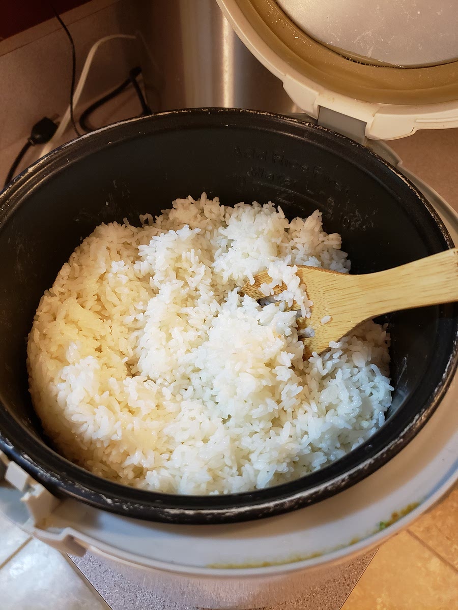 Once the rice is cooked, let it sit with the lid closed for 5 minutes, then stir with a wooden spoon and let it cool for another 5 minutes.