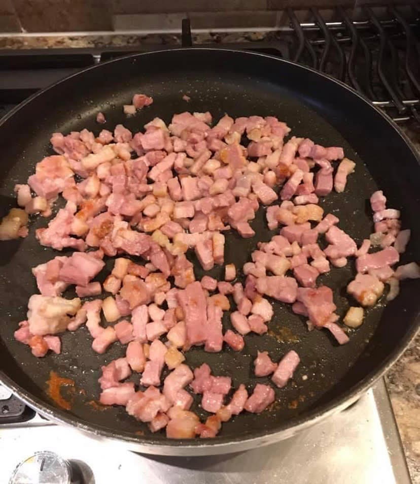 Brown the bacon lardons in a pan and add to the slow cooker, brown the chicken thighs in the same pan with the crushed garlic.
