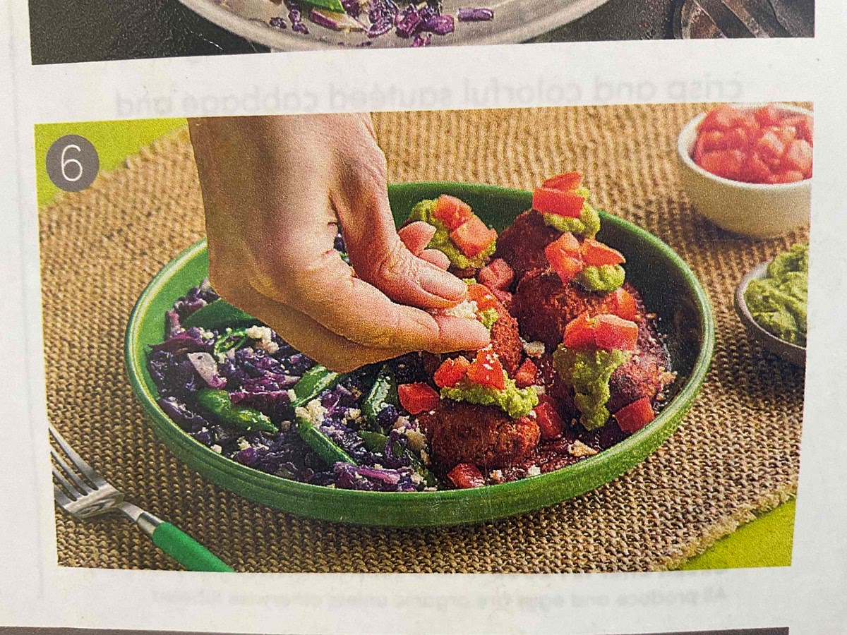 Make a pool of enchilada sauce on one side of each plate. Top with smothered pork meatballs. Garnish meatballs with guacamole and tomato. Serve sautéed cabbage and snap peas next to meatballs. Sprinkle cotija cheese over dishes. Enjoy!