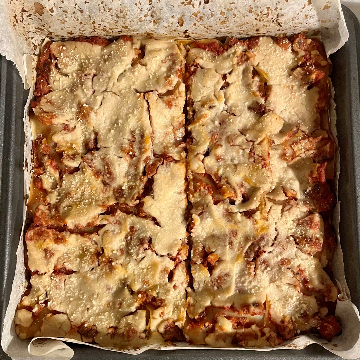 Cover with foil and bake for 25 mins. Remove foil and bake another 10 - 15 minutes until bubbling around the edges. Optionally you can brown the cheese by putting it under the broiler for a few minutes, keeping a close eye to ensure it doesn't burn. Allow the lasagna to cool for 10 minutes before serving. Top with fresh chopped basil, parsley, or vegan parmesan cheese if desired.