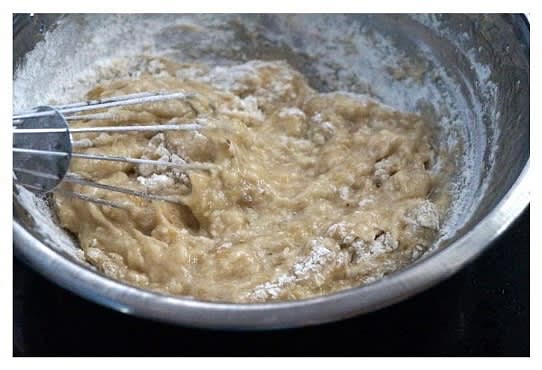 Slowly add the sifted flour to the banana mixture and gently fold the mixture until the batter shows no trace of flour. Don’t overmix or overbeat.