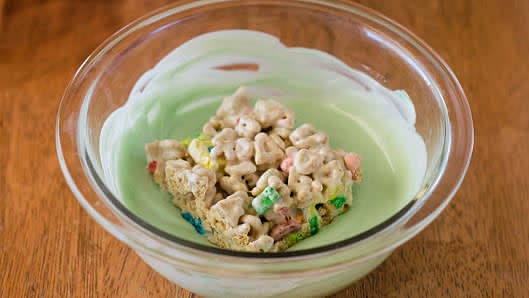 Cut cooled cereal mixture into 4 rows by 4 rows to make 16 bars. Dip bottom of each bar into melted candy coating, spread evenly. Place coating side up on sheet of waxed paper; let stand until coating is set before serving.