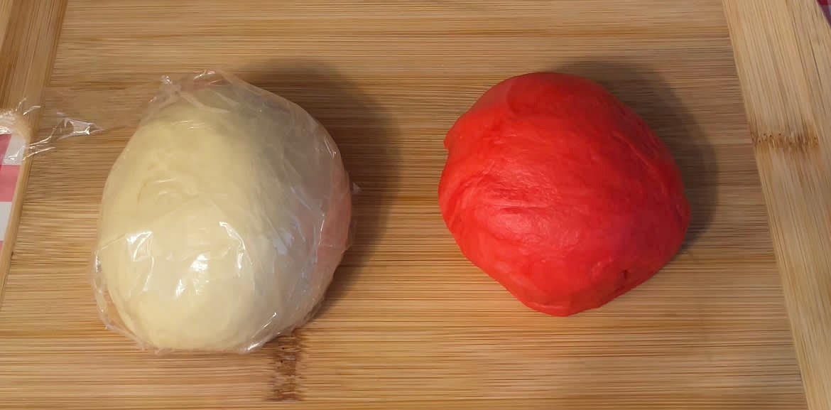 Form the dough into a ball and split it into 2 equal portions. Add the food colouring to 1/2 of the dough and knead for 5-10 mins until well combined.