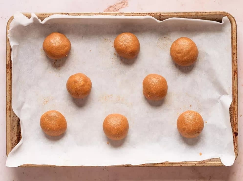 Place parchment paper on to a baking sheet. Roll mixture into 1-inch balls and 1-inch apart on your baking sheet.