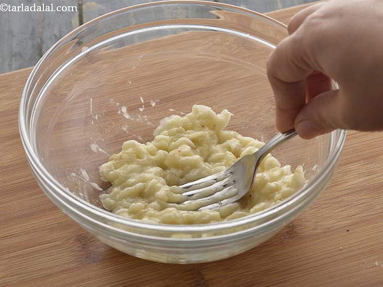 Next, peel and mash together the 3 bananas with a fork until chunky applesauce consistency.