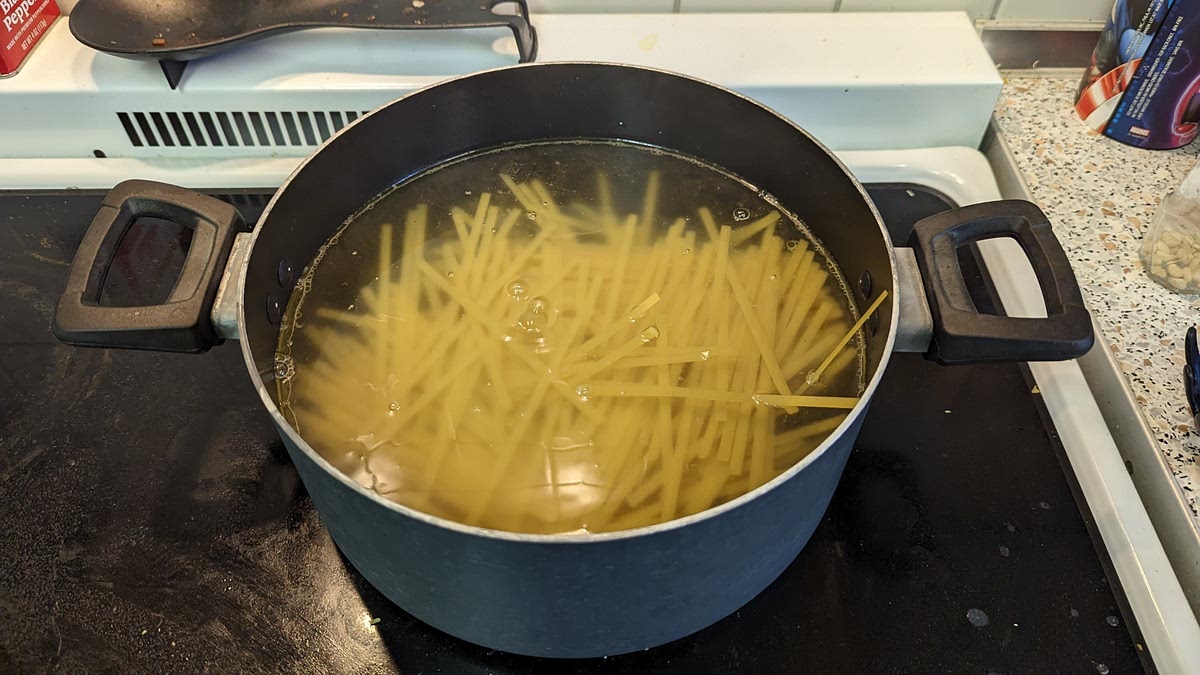 Begin cooking 8 - 12 oz of fettuccine noodles in a separate pot. Stir frequently to avoid noodles from scratch sticking together.