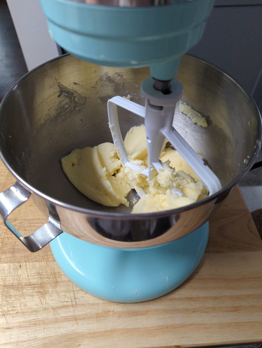 Cream shortening and sugar in a mixer