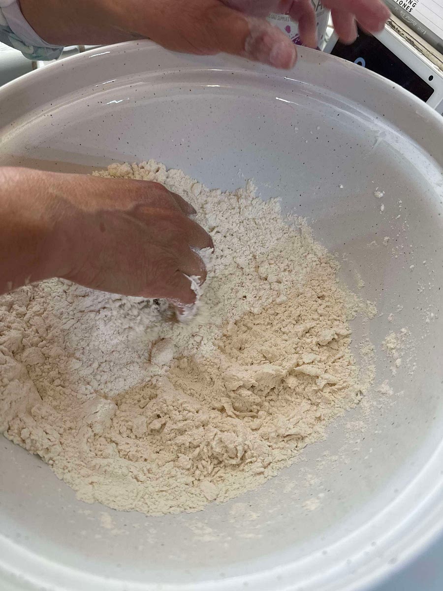Add 1/3 of a cup of shortening and mix together by hand till shortening is broken up